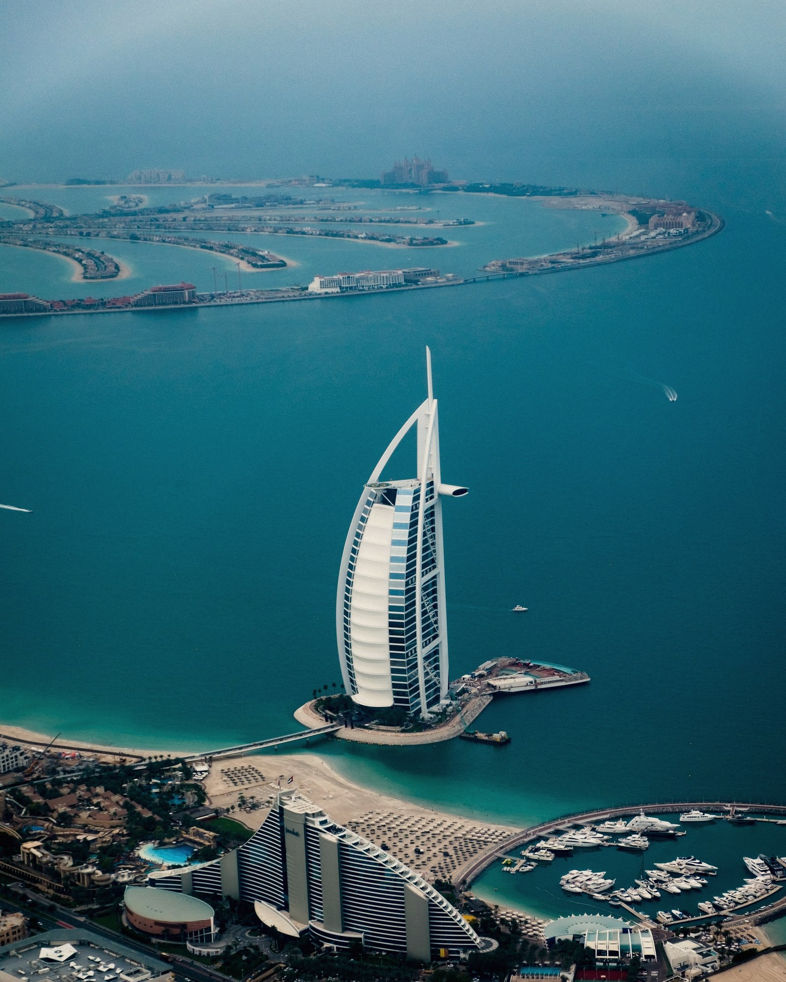 An aerial view of Palm Jumeirah and the Burj Al Arab at dusk.